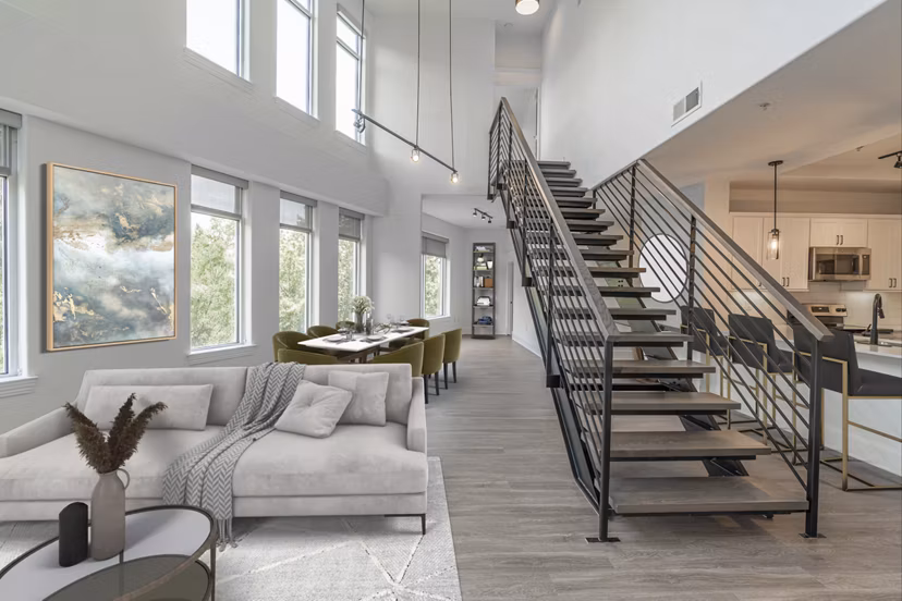 Living room with modern decor and large windows at The Residence at SouthPark Apartments