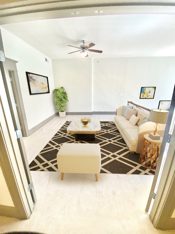 Spacious living room with modern furnishings in The Residence at SouthPark Apartments