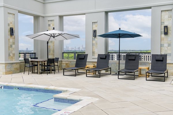 Luxury pool area with lounge seating at The Residence at SouthPark Apartments, perfect for relaxation and recreation