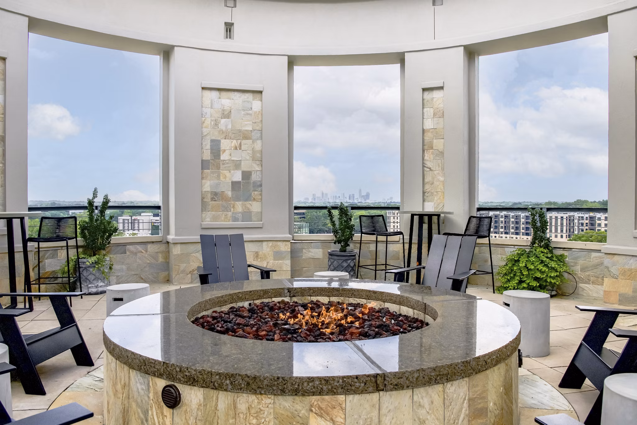 Cozy outdoor fire pit area at The Residence at SouthPark Apartments, perfect for gatherings and relaxation
