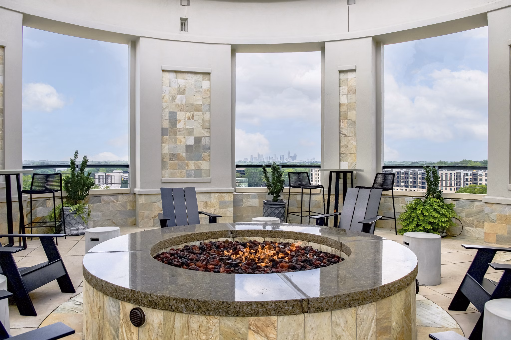 Cozy outdoor fire pit area at The Residence at SouthPark Apartments, perfect for gatherings and relaxation