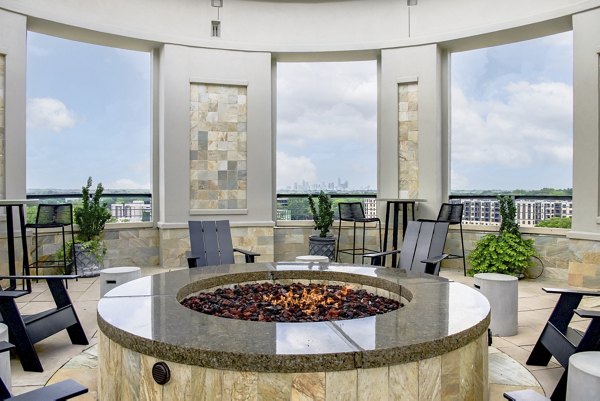 Cozy outdoor fire pit area at The Residence at SouthPark Apartments, perfect for gatherings and relaxation