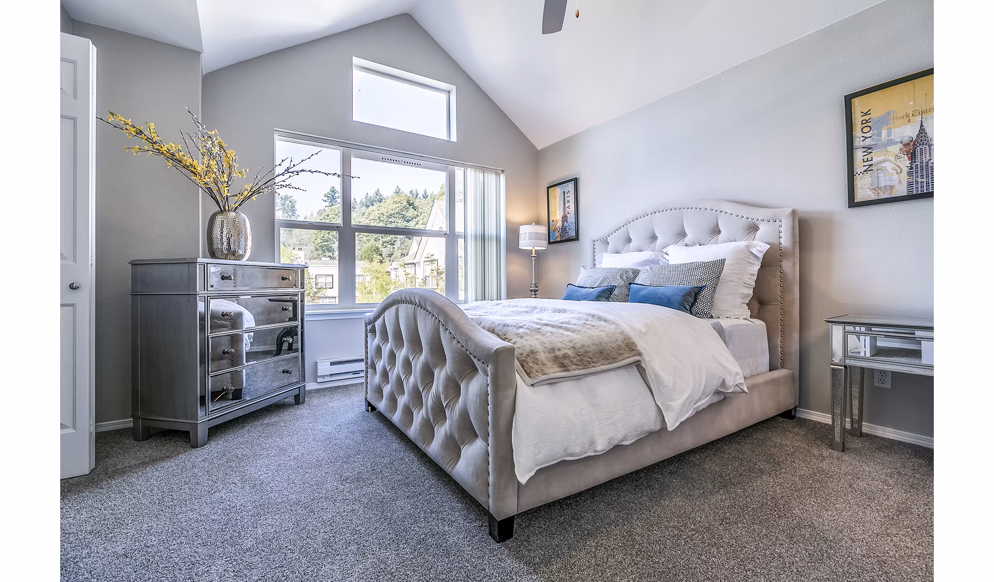 Spacious bedroom with modern decor in Avignon Townhomes Apartments, featuring large windows and neutral tones for a luxurious living experience