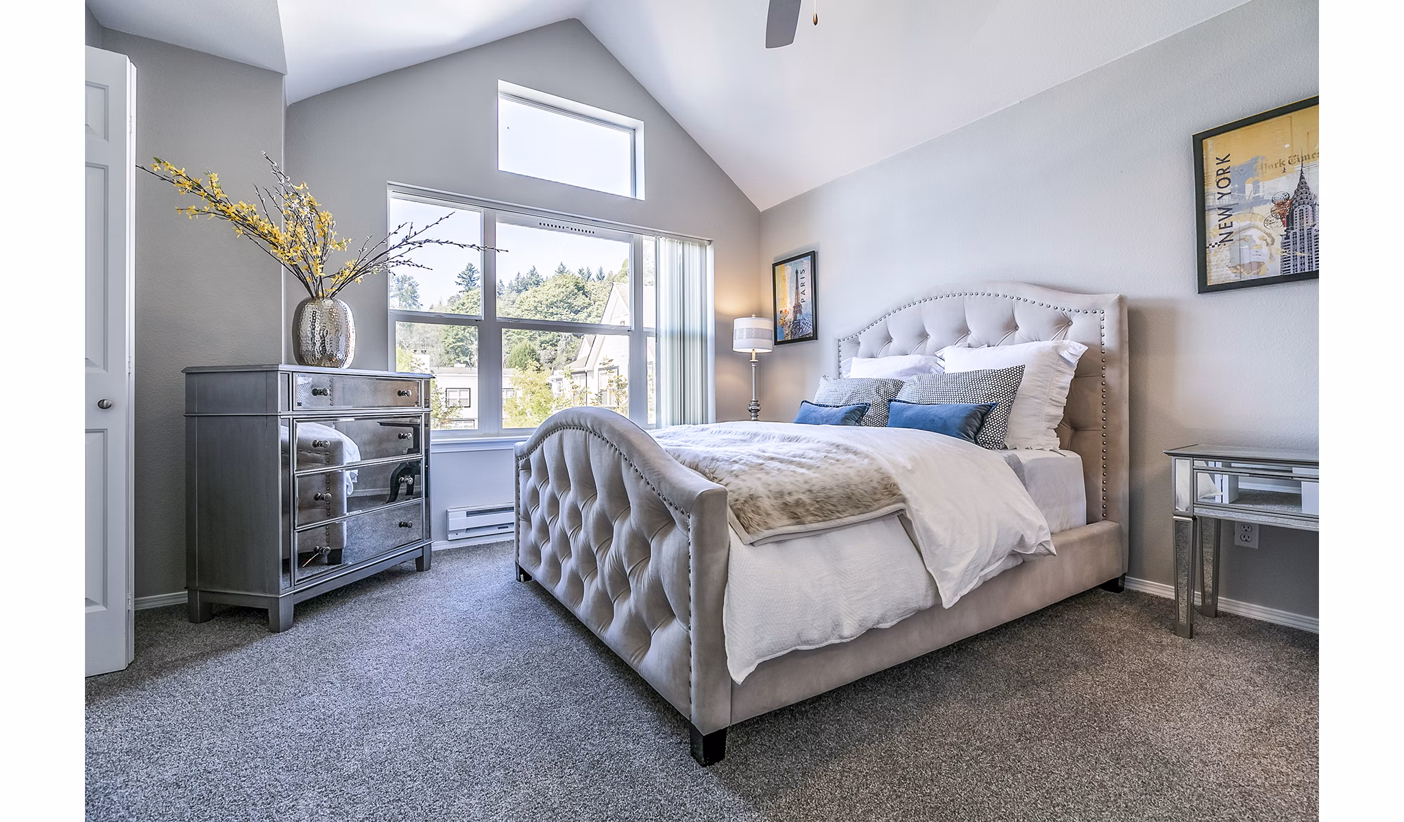 Spacious bedroom with modern decor in Avignon Townhomes Apartments, featuring large windows and neutral tones for a luxurious living experience