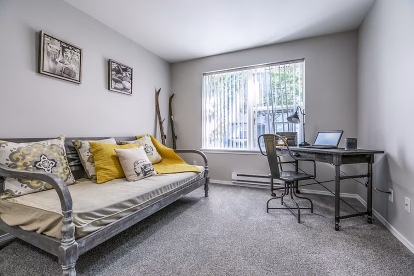 Bedroom/office combo featuring built-in desk and cozy decor at Avignon Townhomes Apartments