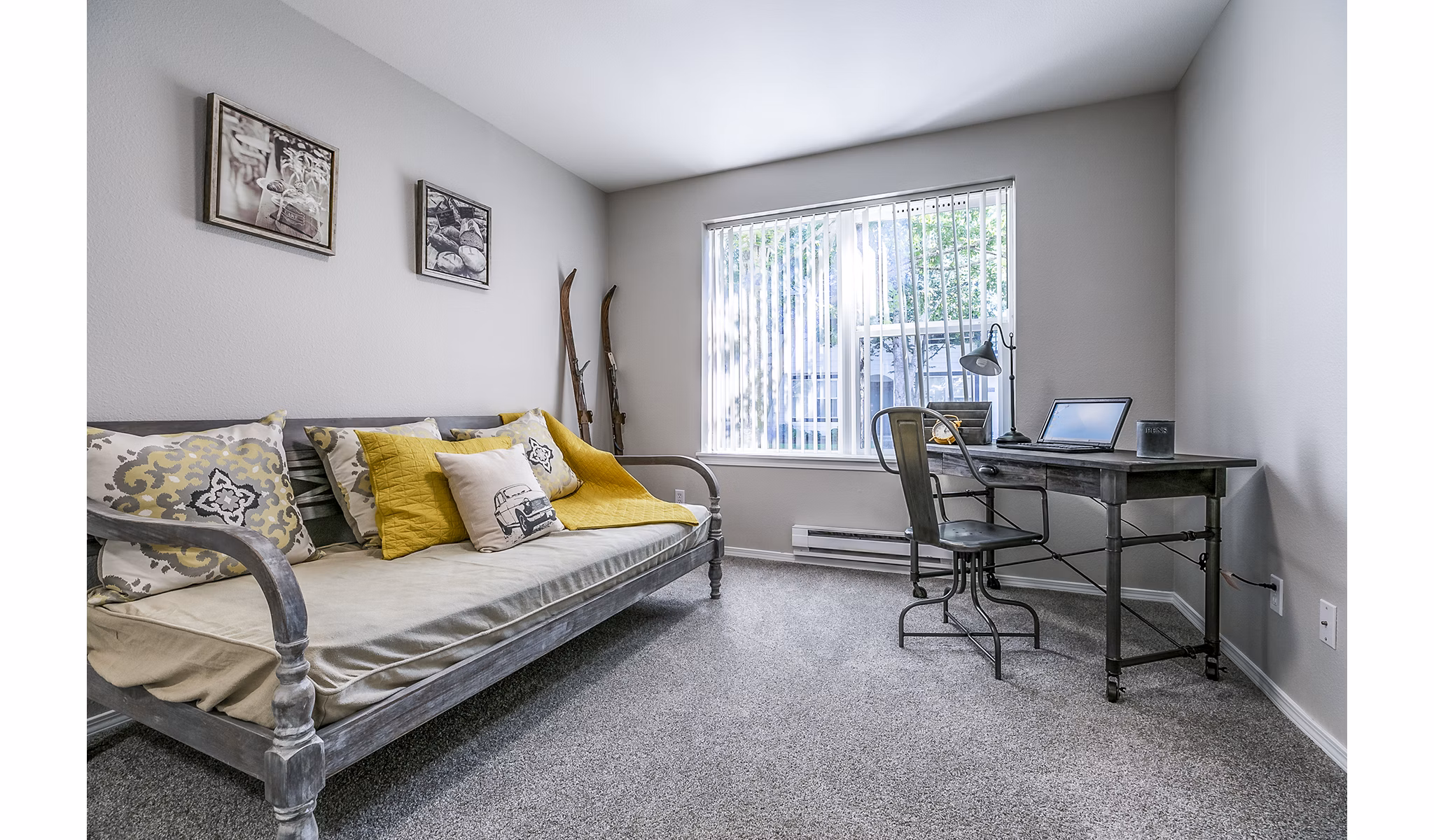 Bedroom/office combo featuring built-in desk and cozy decor at Avignon Townhomes Apartments