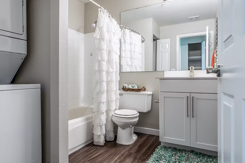 Modern bathroom featuring marble countertops and glass shower in Avignon Townhomes Apartments