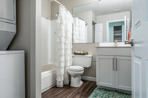 Modern bathroom featuring marble countertops and glass shower in Avignon Townhomes Apartments