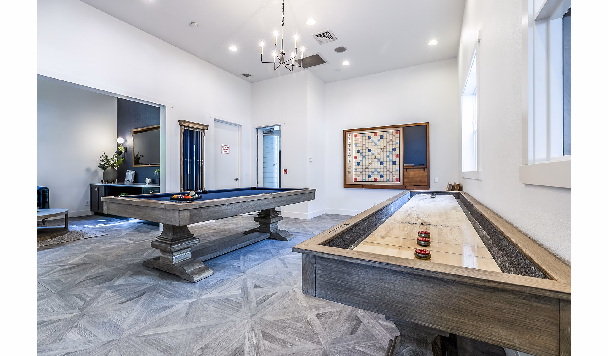 Clubhouse game room with pool table and lounge seating at Avignon Townhomes Apartments