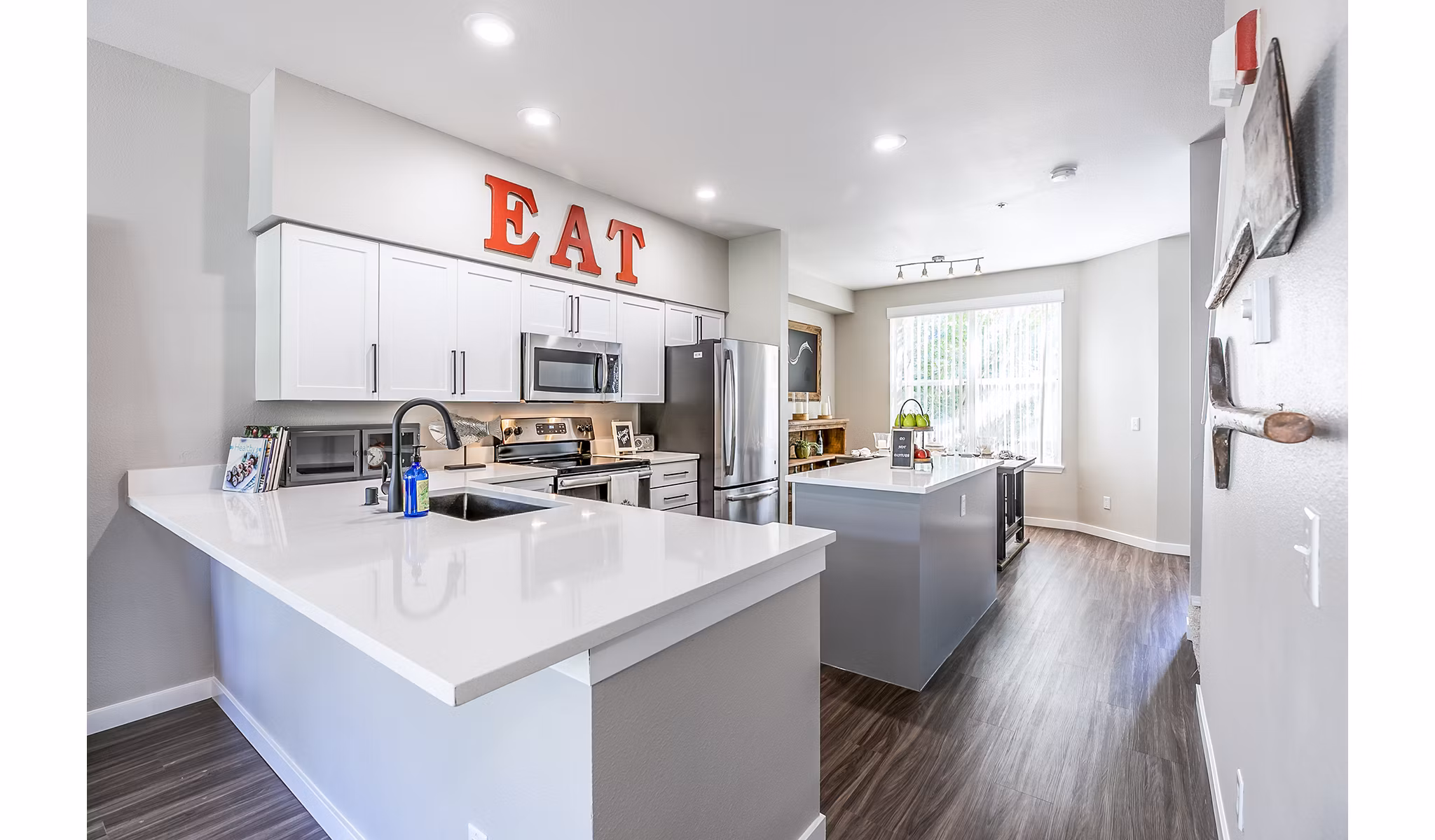 Modern kitchen with stainless steel appliances in Avignon Townhomes Apartments