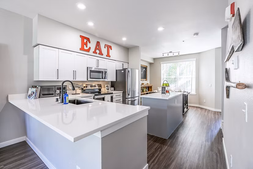 Modern kitchen with stainless steel appliances in Avignon Townhomes Apartments