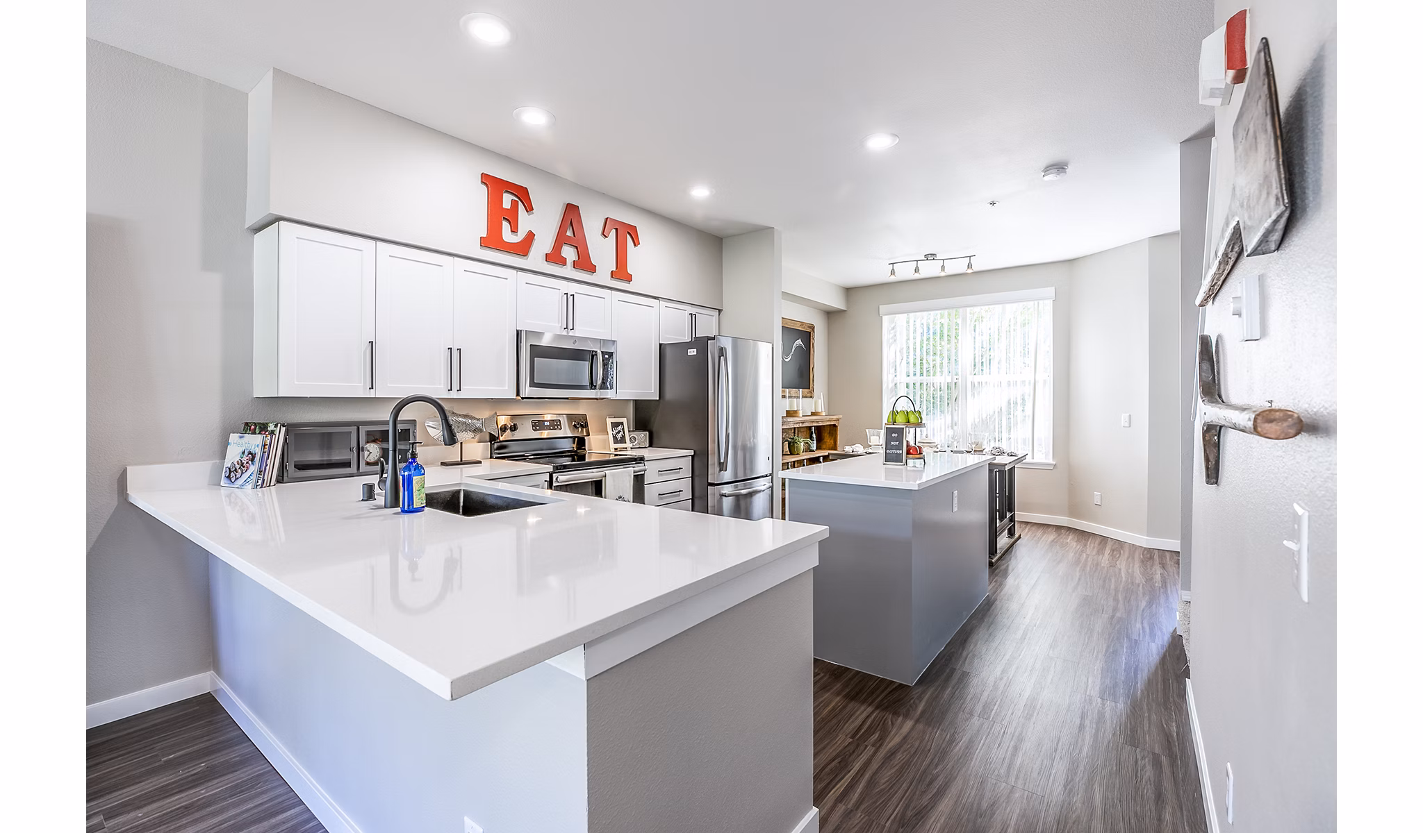Modern kitchen with stainless steel appliances in Avignon Townhomes Apartments