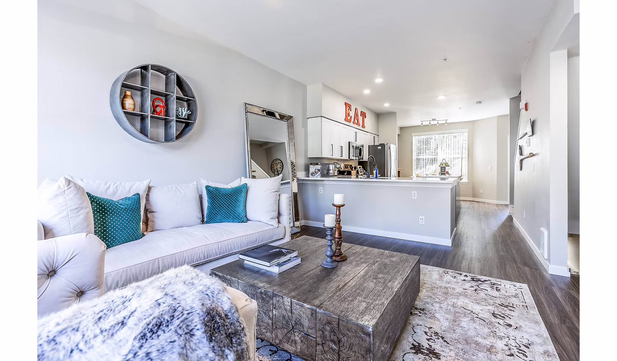 Living room with chic decor and natural lighting at Avignon Townhomes, luxury apartments by Greystar
