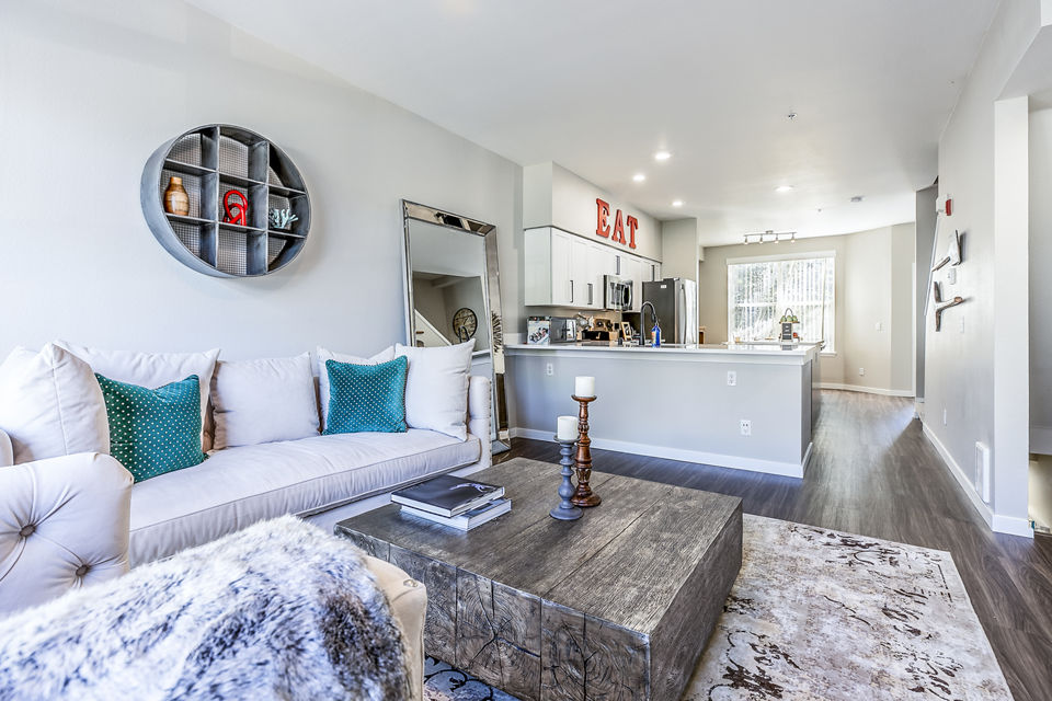 Living room with chic decor and natural lighting at Avignon Townhomes, luxury apartments by Greystar