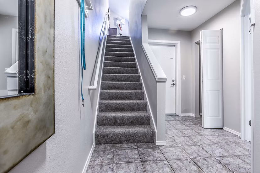 Elegant stairway design in Avignon Townhomes Apartments, featuring modern architecture and sleek finishes