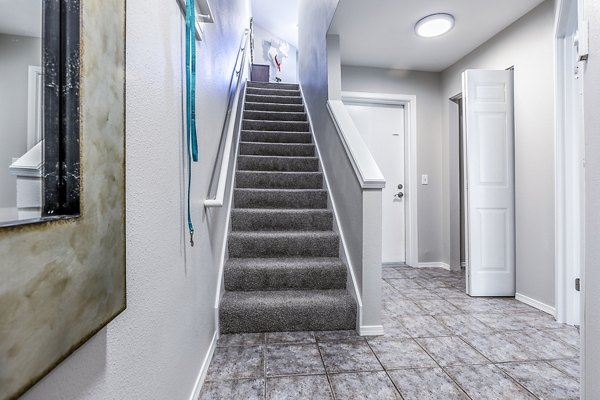 Elegant stairway design in Avignon Townhomes Apartments, featuring modern architecture and sleek finishes