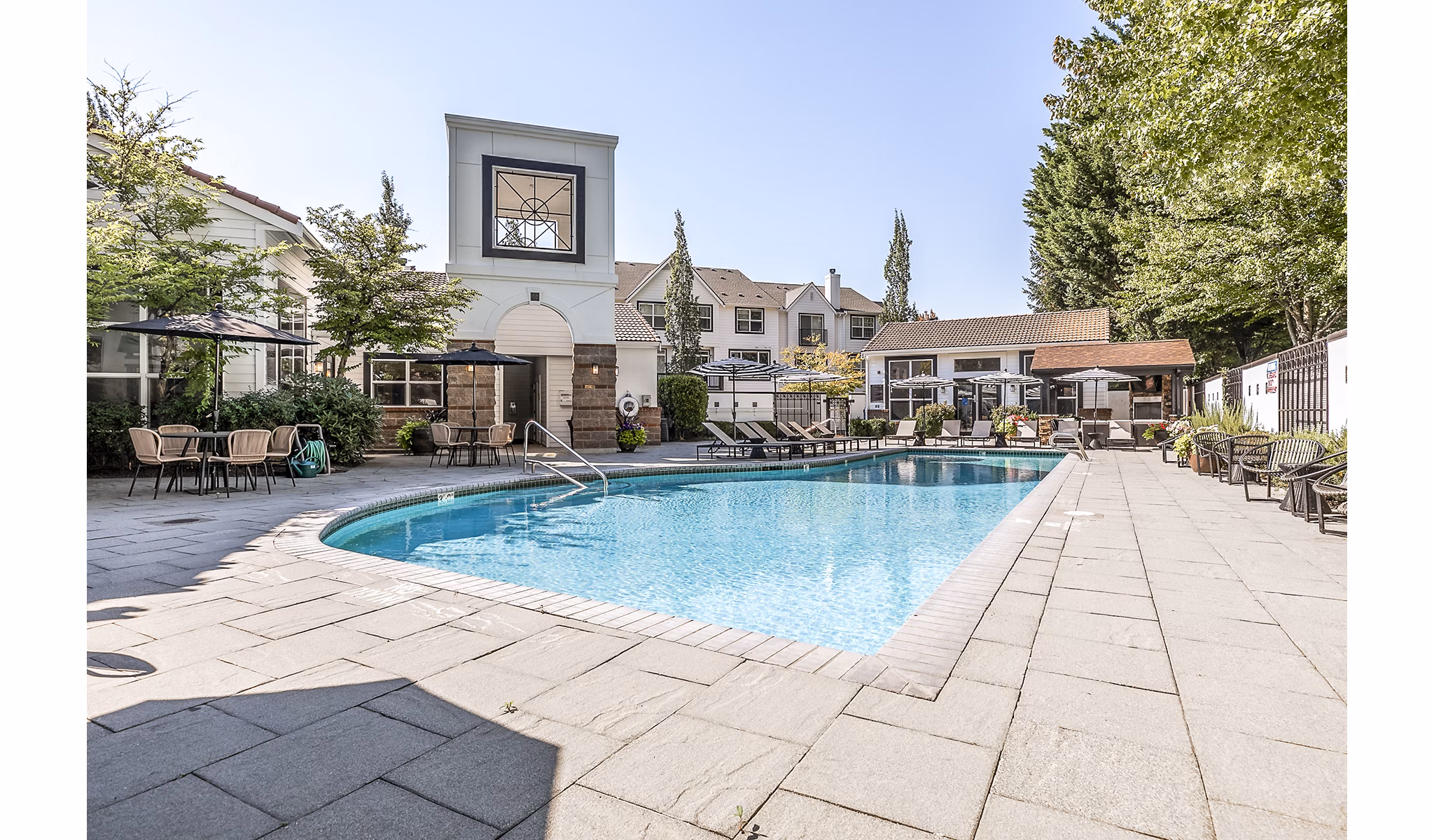 Olympic-sized pool at Avignon Townhomes Apartments with surrounding lounge areas