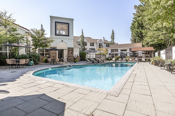 Olympic-sized pool at Avignon Townhomes Apartments with surrounding lounge areas