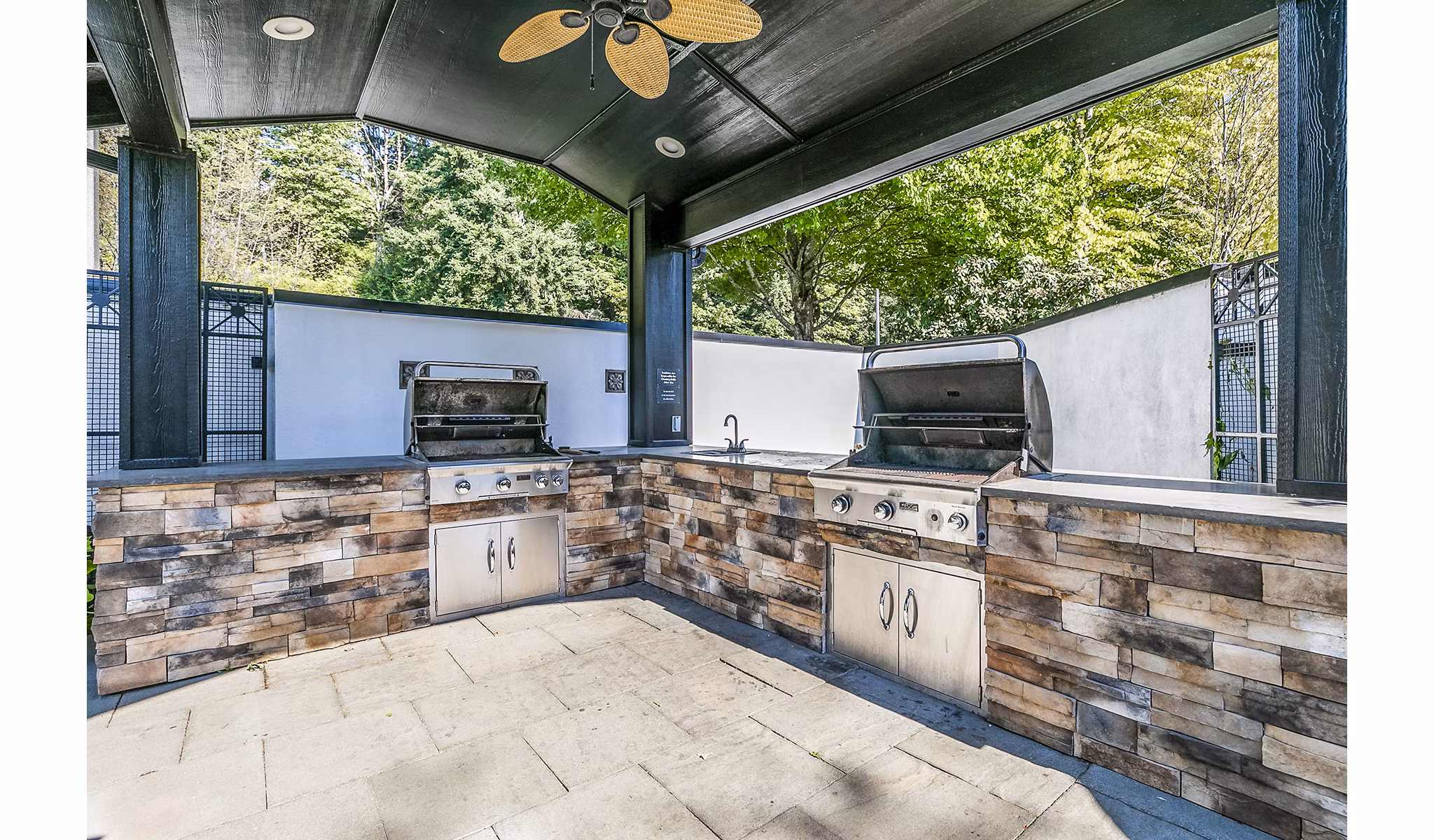 Grill area with outdoor seating at Avignon Townhomes Apartments, luxury living spaces ideal for social gatherings and casual dining