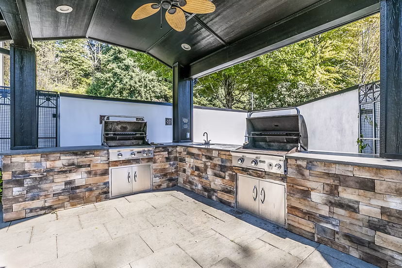 Grill area with outdoor seating at Avignon Townhomes Apartments, luxury living spaces ideal for social gatherings and casual dining