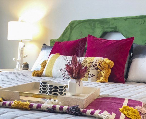 Modern bedroom featuring elegant decor and large windows at Savoy Apartments
