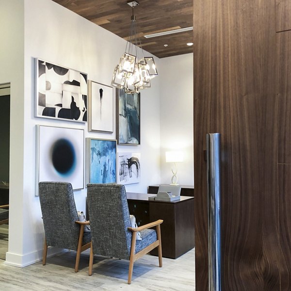 Modern business center featuring workstations and conference seating at Savoy Apartments