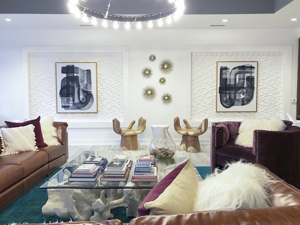 Modern clubhouse with pool tables and seating at Savoy Apartments, offering luxury living in a vibrant community