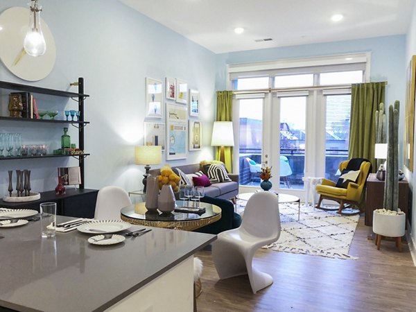 Living room with contemporary decor and natural light at Savoy Apartments, luxury property by Greystar