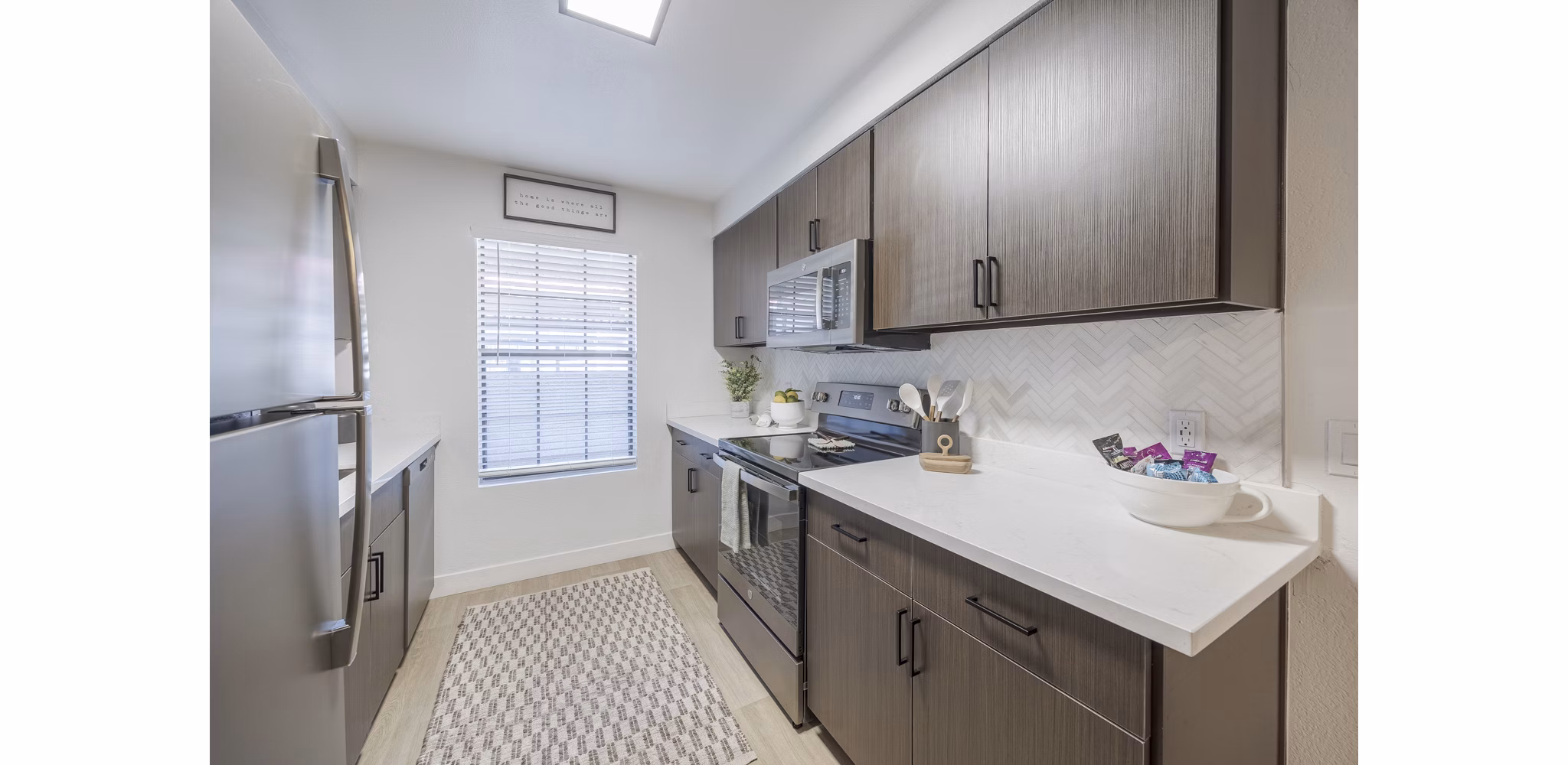 Modern kitchen with stainless steel appliances at Sage at Green Valley Apartments