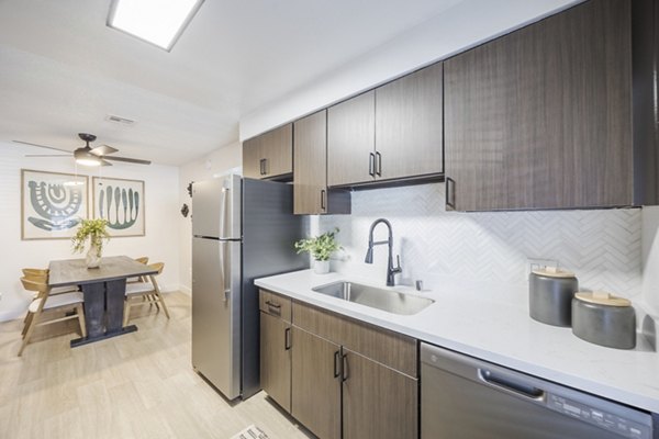 Kitchens: Open-plan kitchen and dining area with modern appliances at Sage at Green Valley Apartments