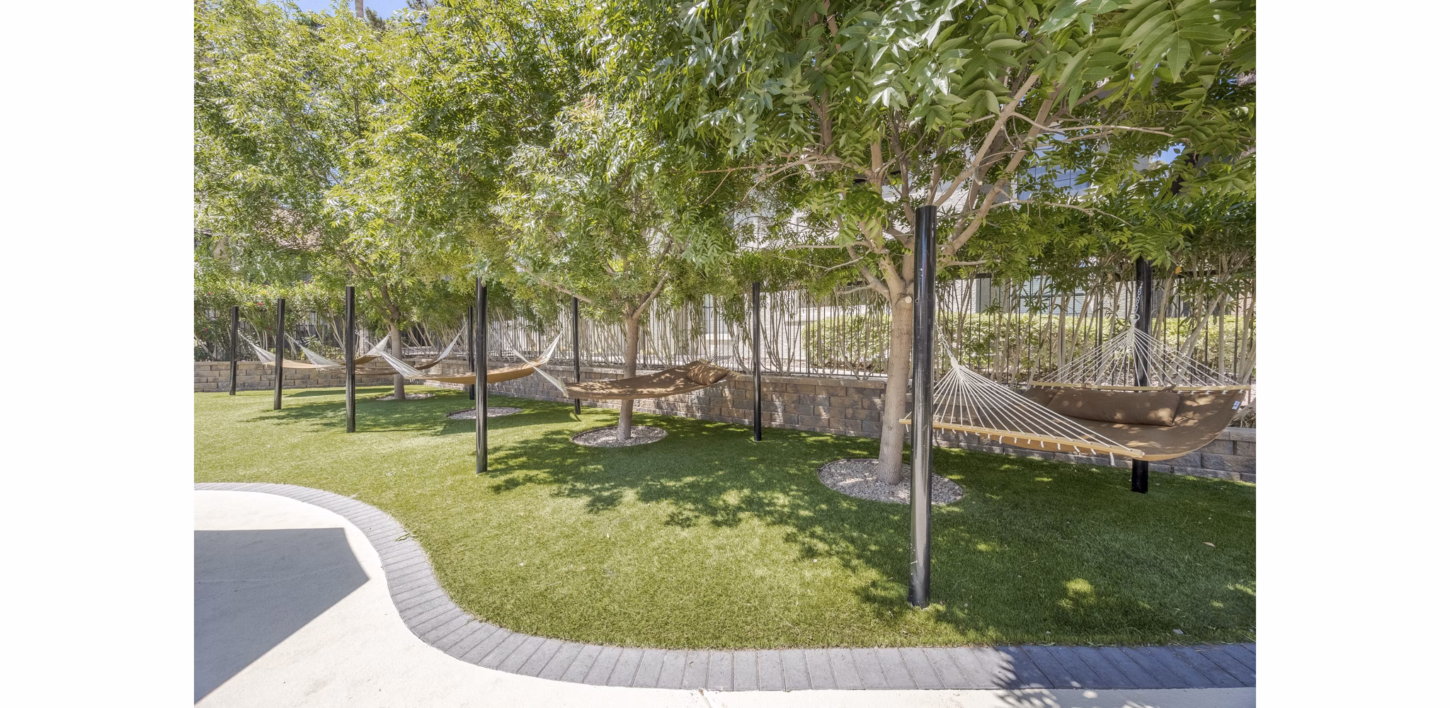 Hammock area on patio at Sage at Green Valley Apartments, luxury outdoor space nearby dining and leisure behind high-rise living