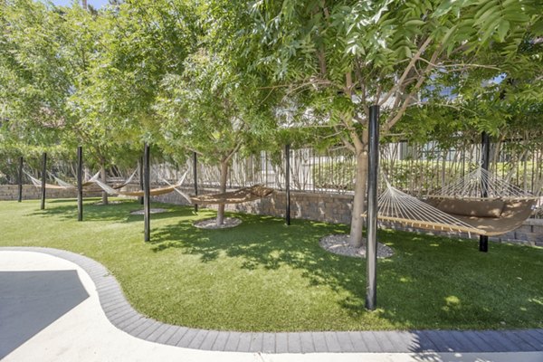 Hammock area on patio at Sage at Green Valley Apartments, luxury outdoor space nearby dining and leisure behind high-rise living
