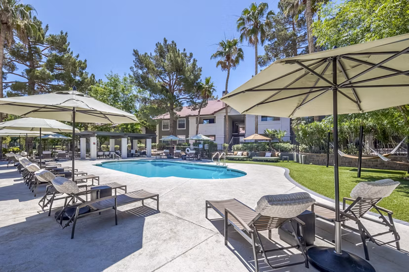 Sage at Green Valley: Relaxing outdoor pool area with modern loungers at luxury apartments