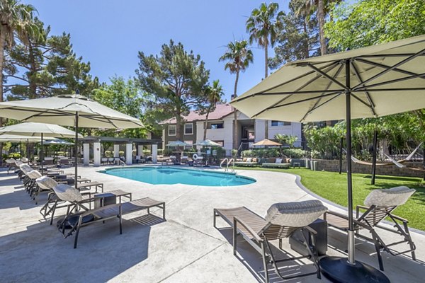 Sage at Green Valley: Relaxing outdoor pool area with modern loungers at luxury apartments