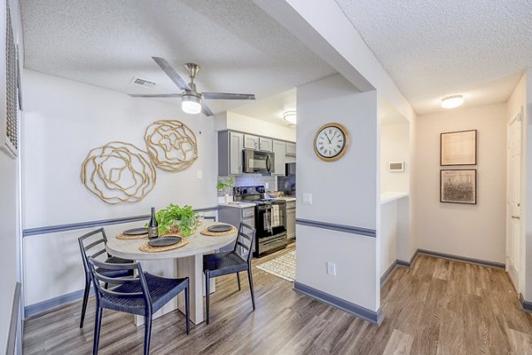 Dining area featuring modern furniture and large windows at 5400 Vistas Apartments luxury rentals