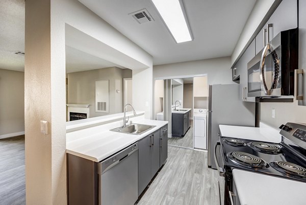 Modern kitchen with stainless steel appliances at 5400 Vistas Apartments