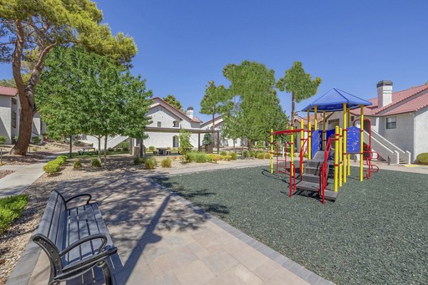 Colorful playground at 5400 Vistas Apartments offering family-friendly recreation spaces and seating areas