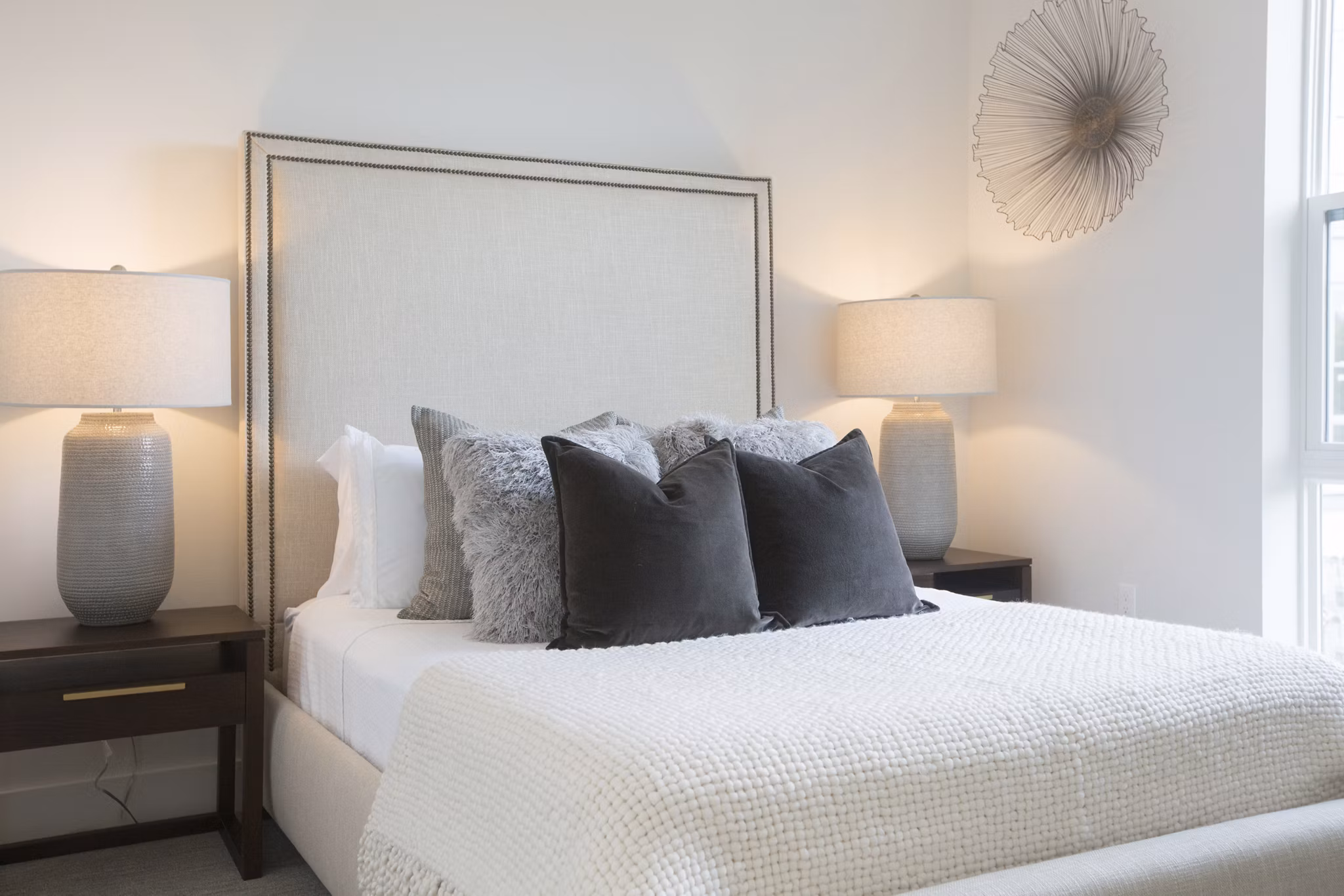 One Beachmont Apartments: Modern bedroom with stylish decor and ample natural light