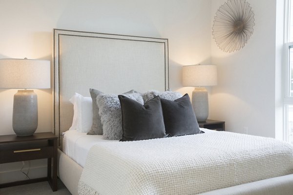 One Beachmont Apartments: Modern bedroom with stylish decor and ample natural light
