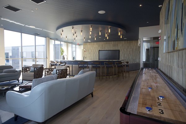 Game room with billiards and lounge seating at One Beachmont Apartments