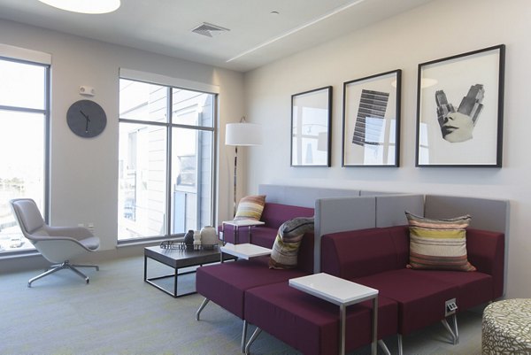 Clubhouse with chic interiors and cozy seating at One Beachmont Apartments