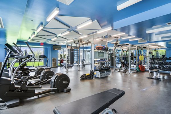 Fully-equipped fitness center at One Beachmont Apartments featuring modern exercise machines and open workout space for residents