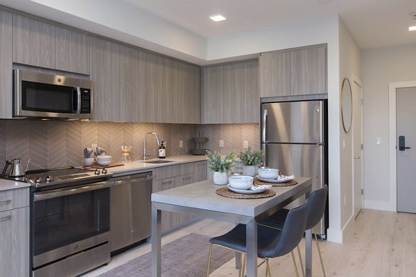 Modern kitchen with stainless steel appliances at One Beachmont Apartments