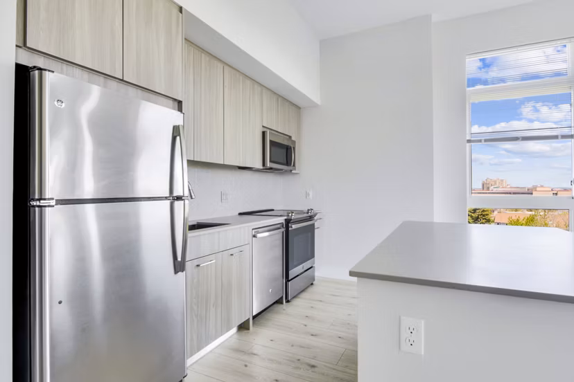 Modern kitchen with sleek countertops and stainless steel appliances in One Beachmont Apartments, Revere MA