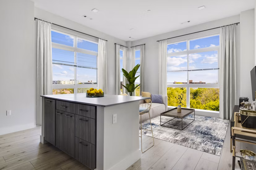 Modern kitchen with stainless steel appliances and quartz countertops in One Beachmont Apartments