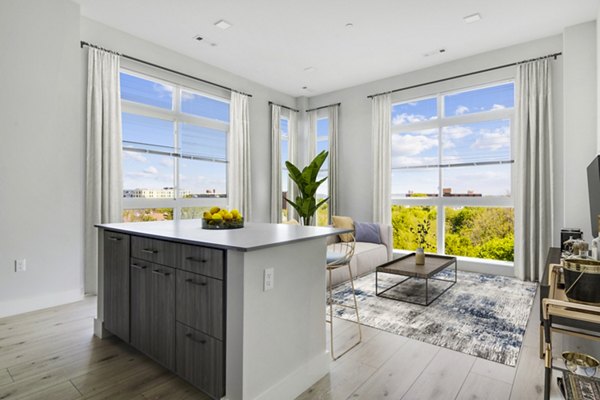 Modern kitchen with stainless steel appliances and quartz countertops in One Beachmont Apartments