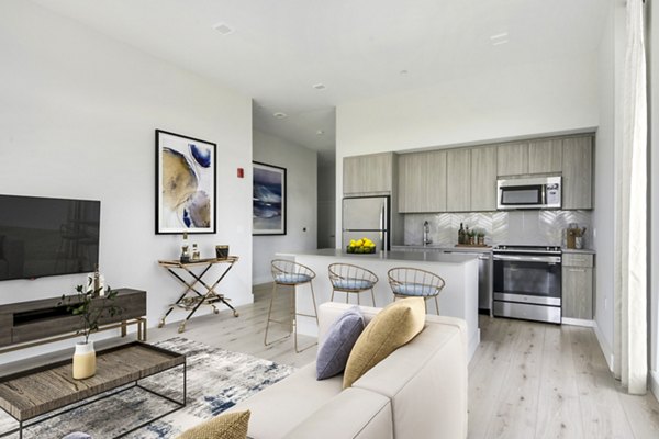 Modern living room with sleek furniture and ocean views at One Beachmont Apartments