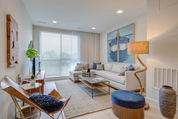 Cozy living room with modern dÃ©cor at One Beachmont Apartments, featuring a stylish seating area and natural light