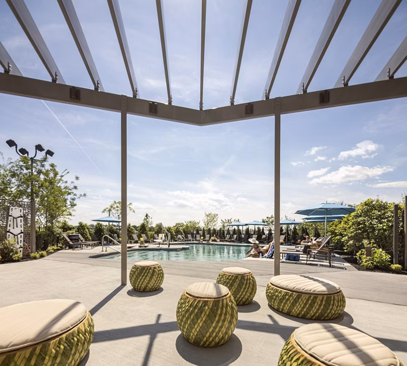 Inviting pool with sundeck at One Beachmont Apartments offering luxury beachfront living