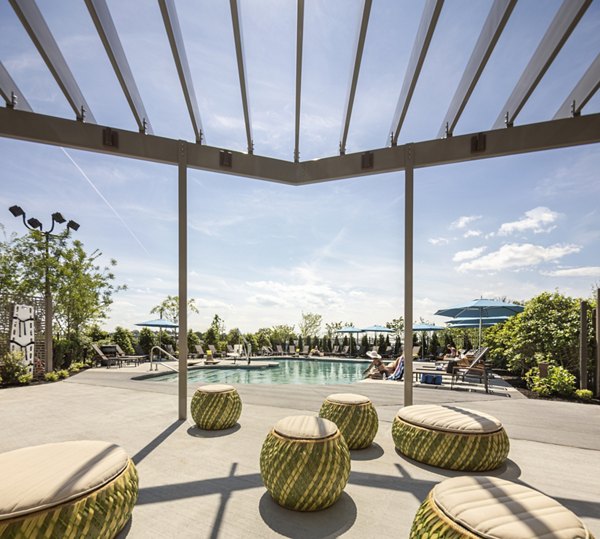 Inviting pool with sundeck at One Beachmont Apartments offering luxury beachfront living
